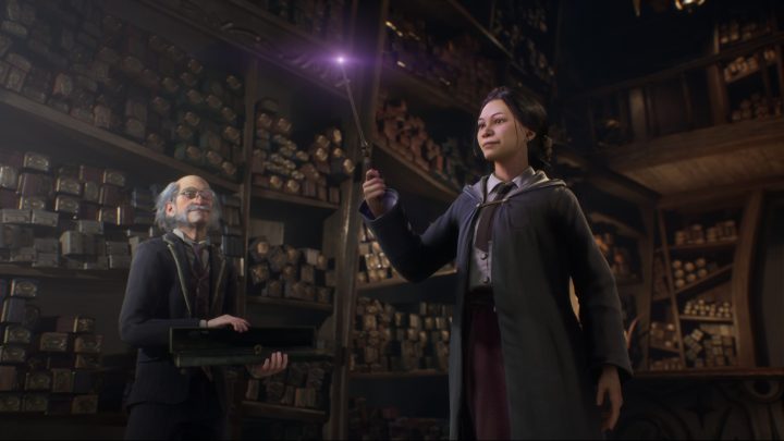 Witch holding a wand in Hogwarts Legacy.