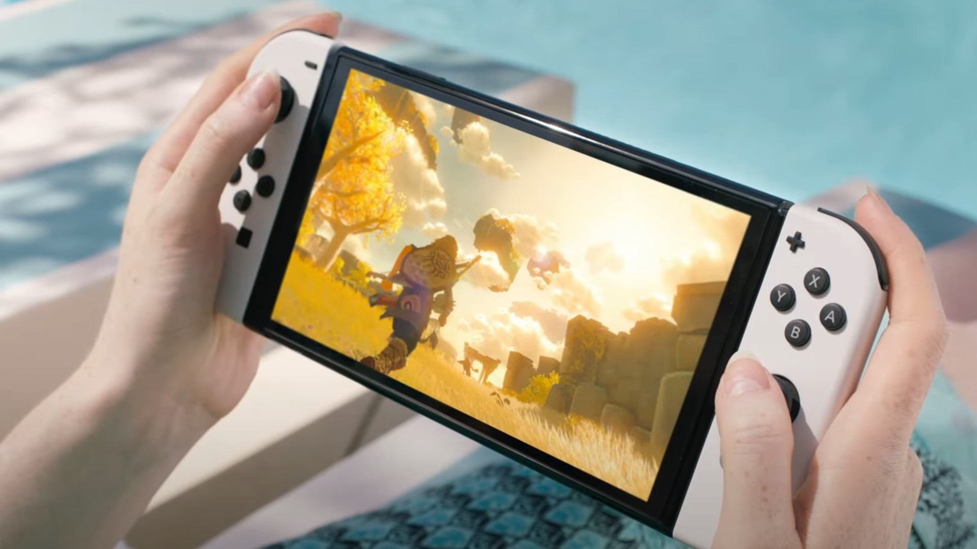 White Nintendo Switch OLED being played in handheld mode