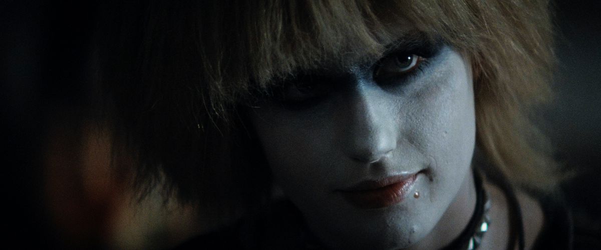 An up-close still shows Daryl Hannah as Pris looking into the camera