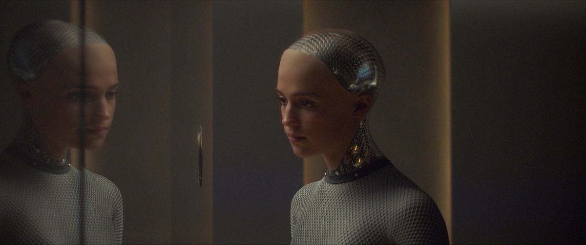Ava, played by Alicia Vikander, looks into a mirror in Ex Machina