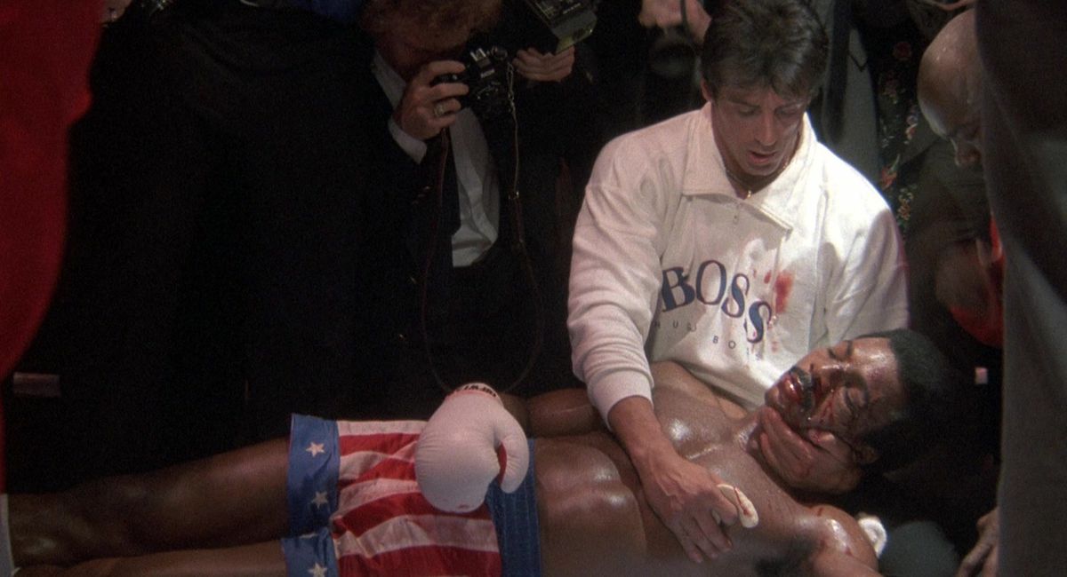 Rocky holds a dying Apollo Creed in his arms after a boxing match
