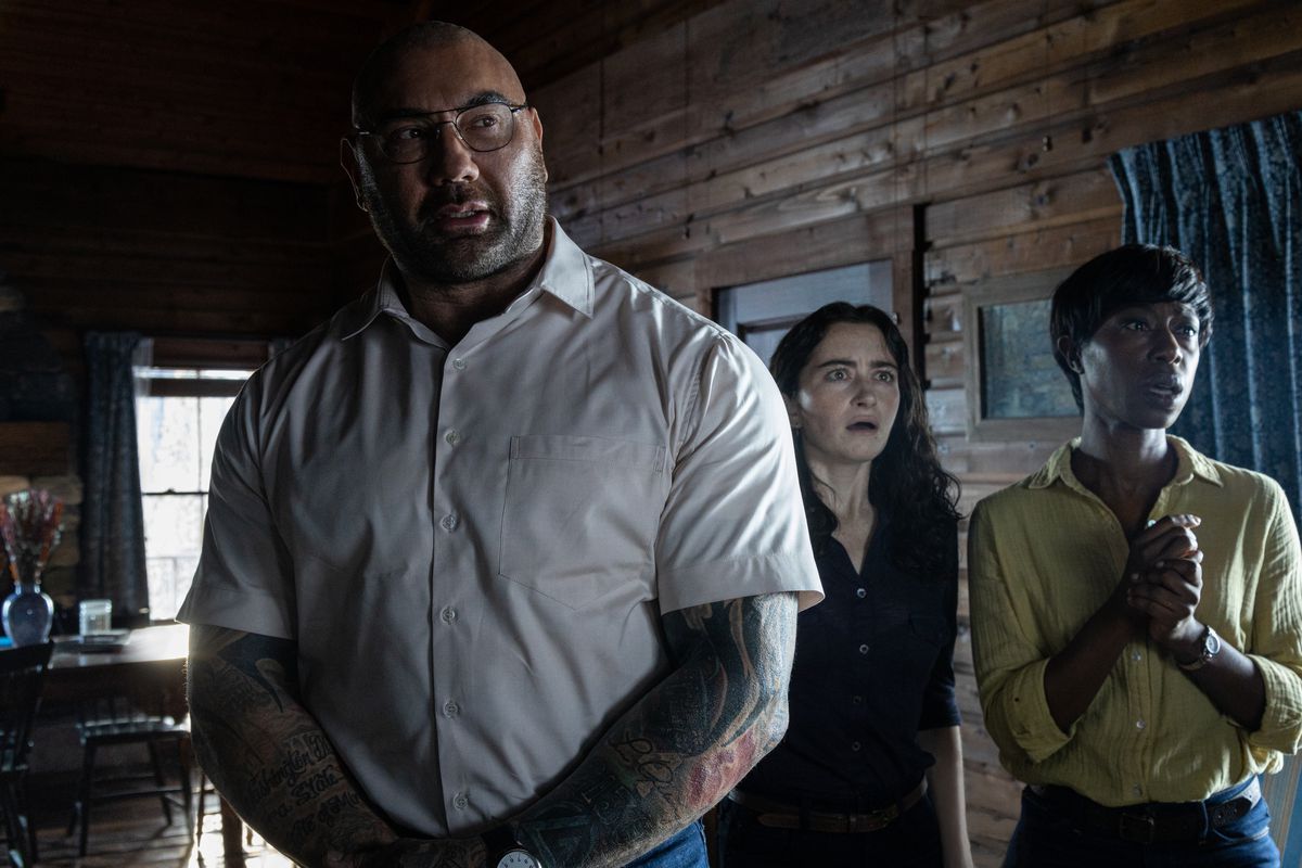 Dave Bautista standing in front of several other people in Knock at the Cabin