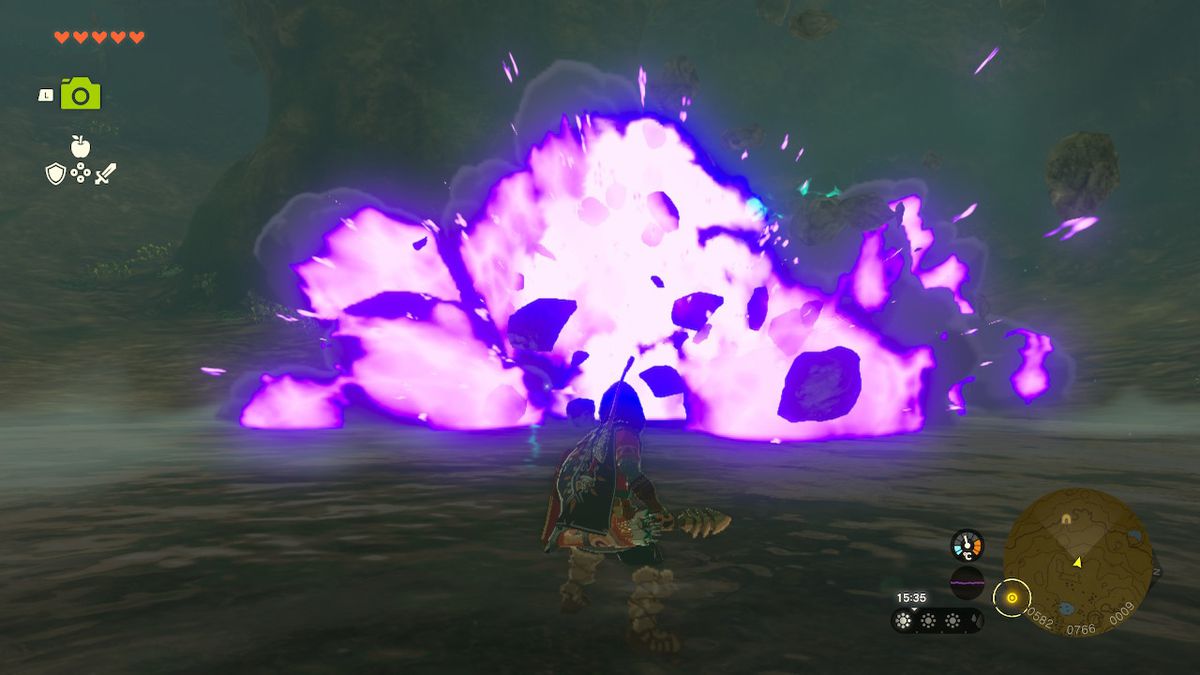 Link stares at a Stone Talus exploding in a cave in Zelda Tears of the Kingdom.